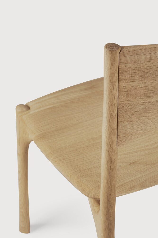 Ethnicraft Pi Dining Chair in oak styled in a dining room