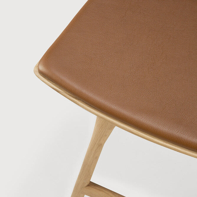 Ethnicraft Osso Bar Stool in oak styled in a dining room