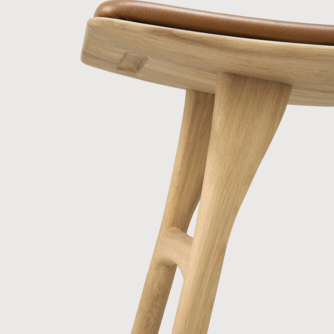 Ethnicraft Osso Bar Stool in oak styled in a dining room