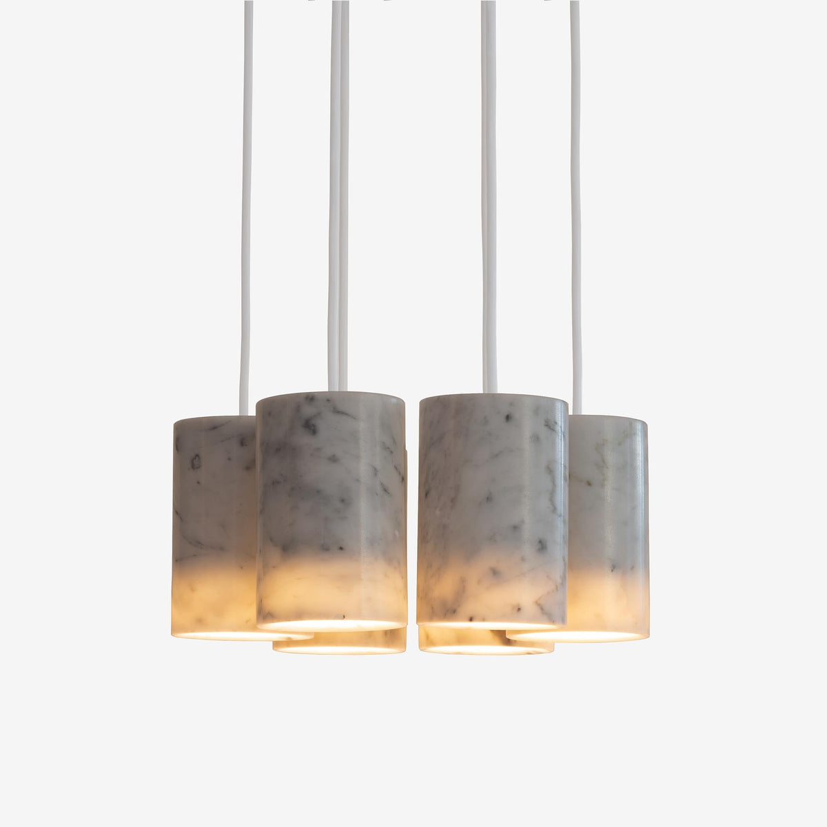 Case Solid Six Pendant Cluster in Carrara, cylinders hung level, Carrara marble