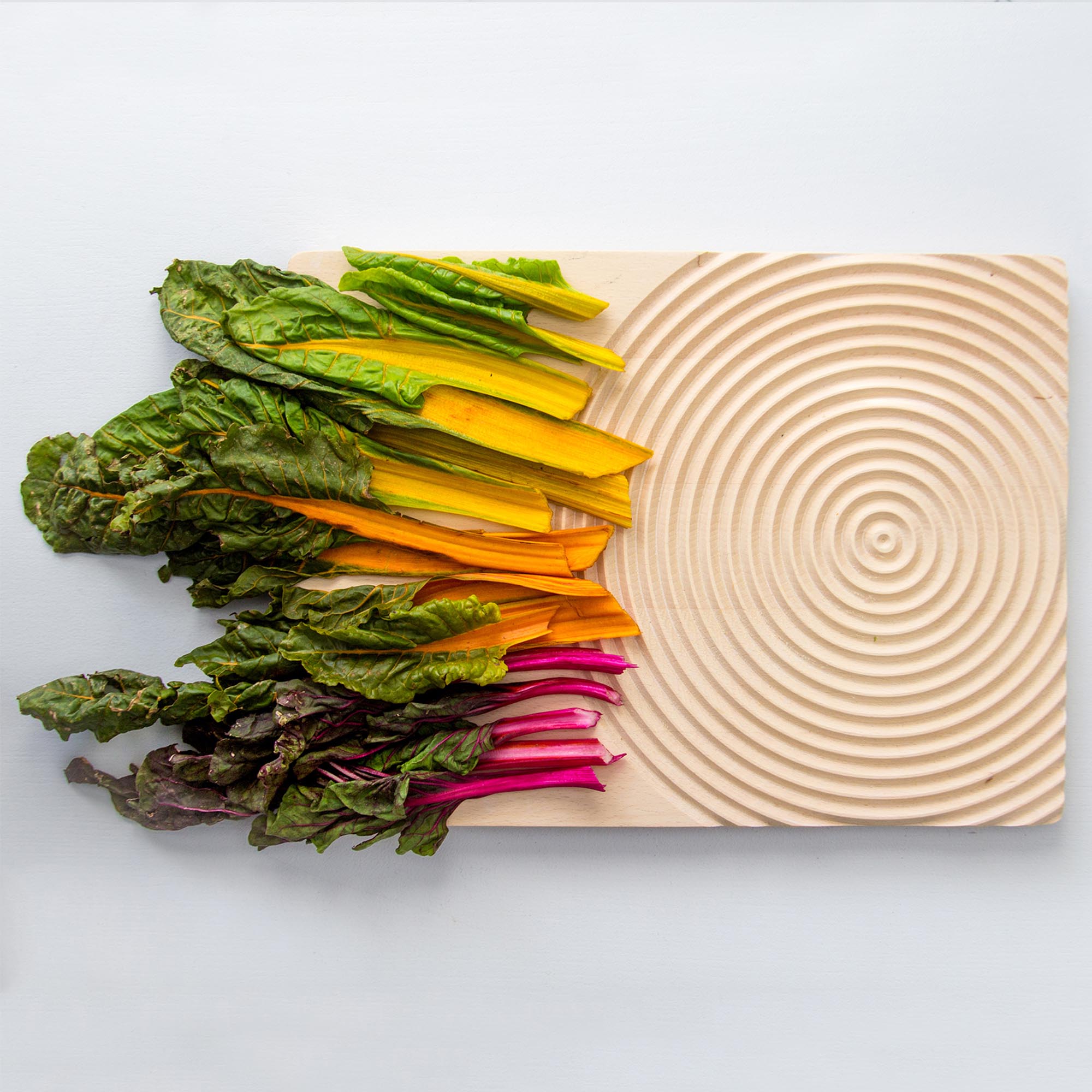 Splash chopping board in rhubarb color, contemporary kitchen piece crafted by Comosum