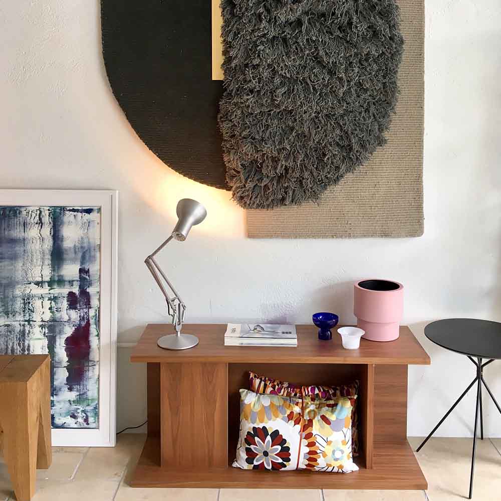 Anglepoise Type 75 desk lamp in Silver Lustre on a wooden console in a bright living room