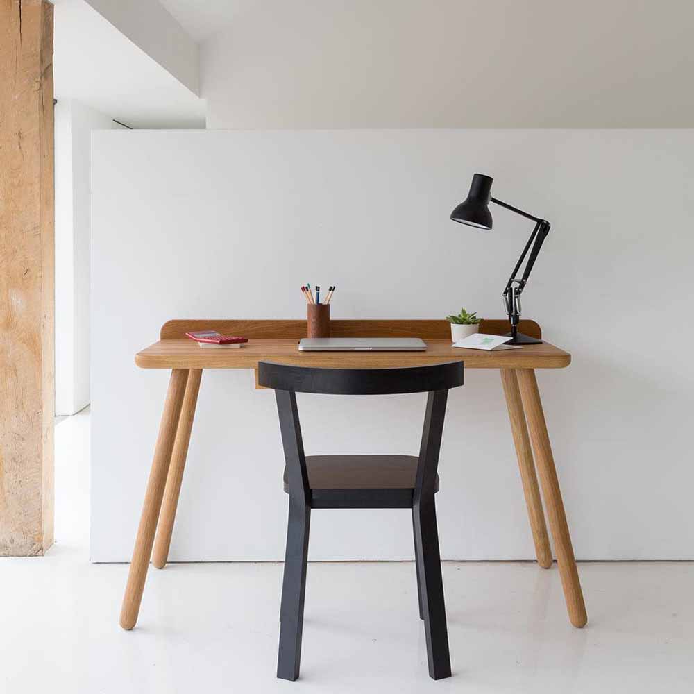 Anglepoise Type 75 Mini lamp in Jet Black on its table base, styled in an interior setting, aluminum