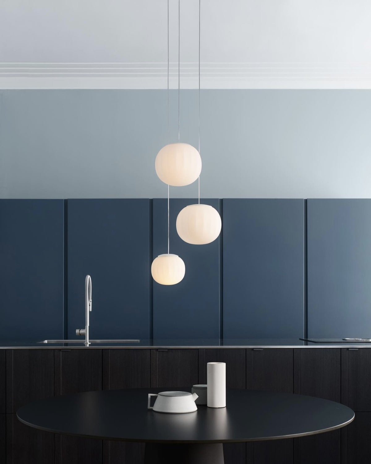 Luceplan Lita Pendants in three sizes over a kitchen table