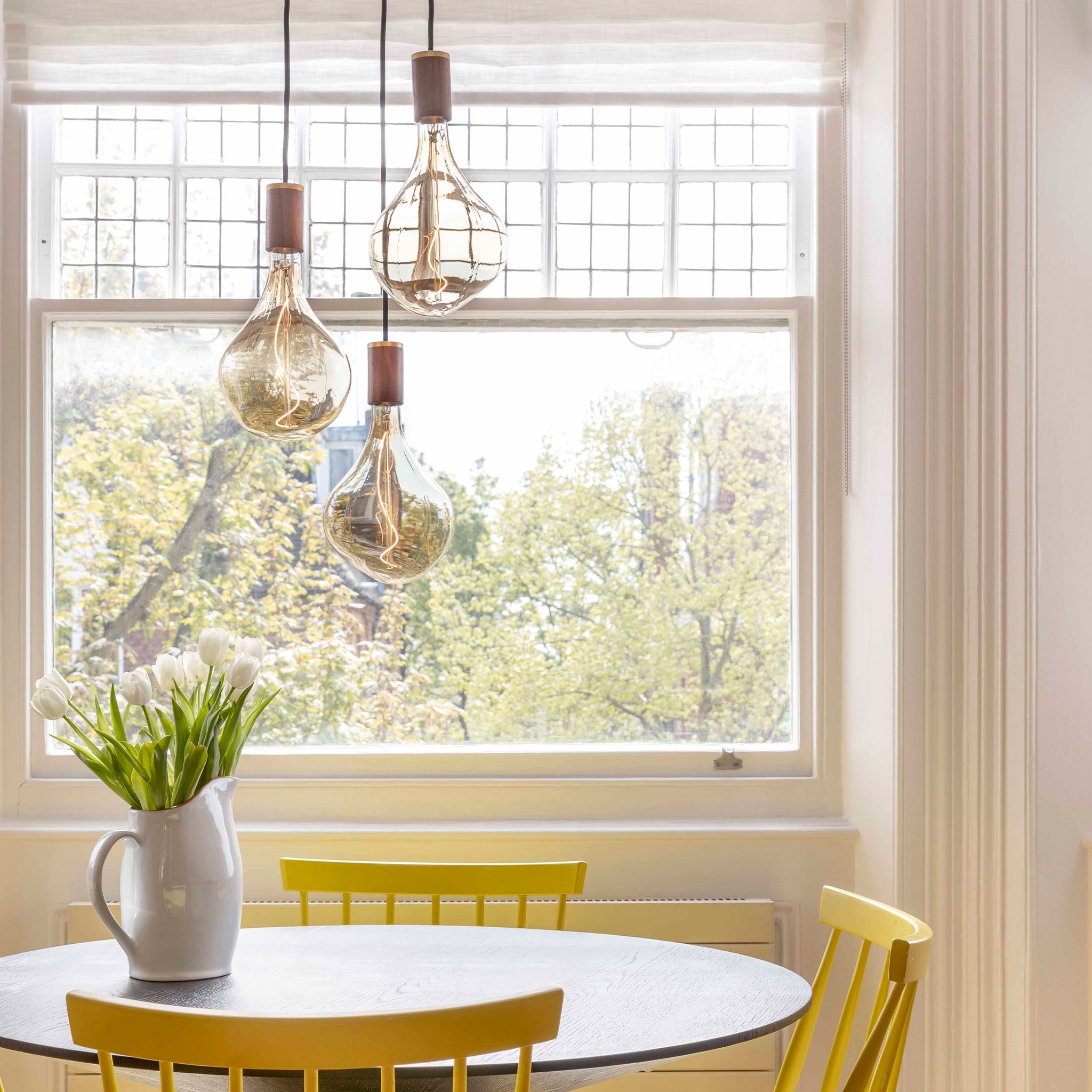 Tala Triple Pendant in Walnut with Voronoi II bulbs — dining room lifestyle