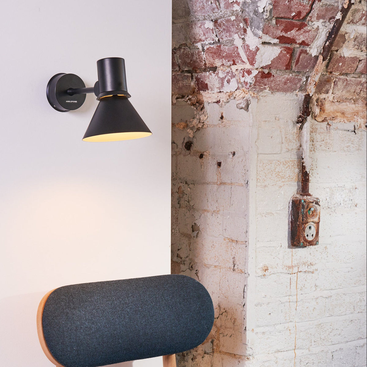 Anglepoise Type 80 wall light in black on a whitewashed brick wall