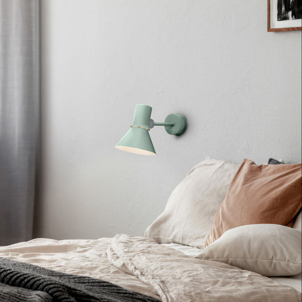 Anglepoise Type 80 wall light in Pistachio Green above a bed with linen bedding