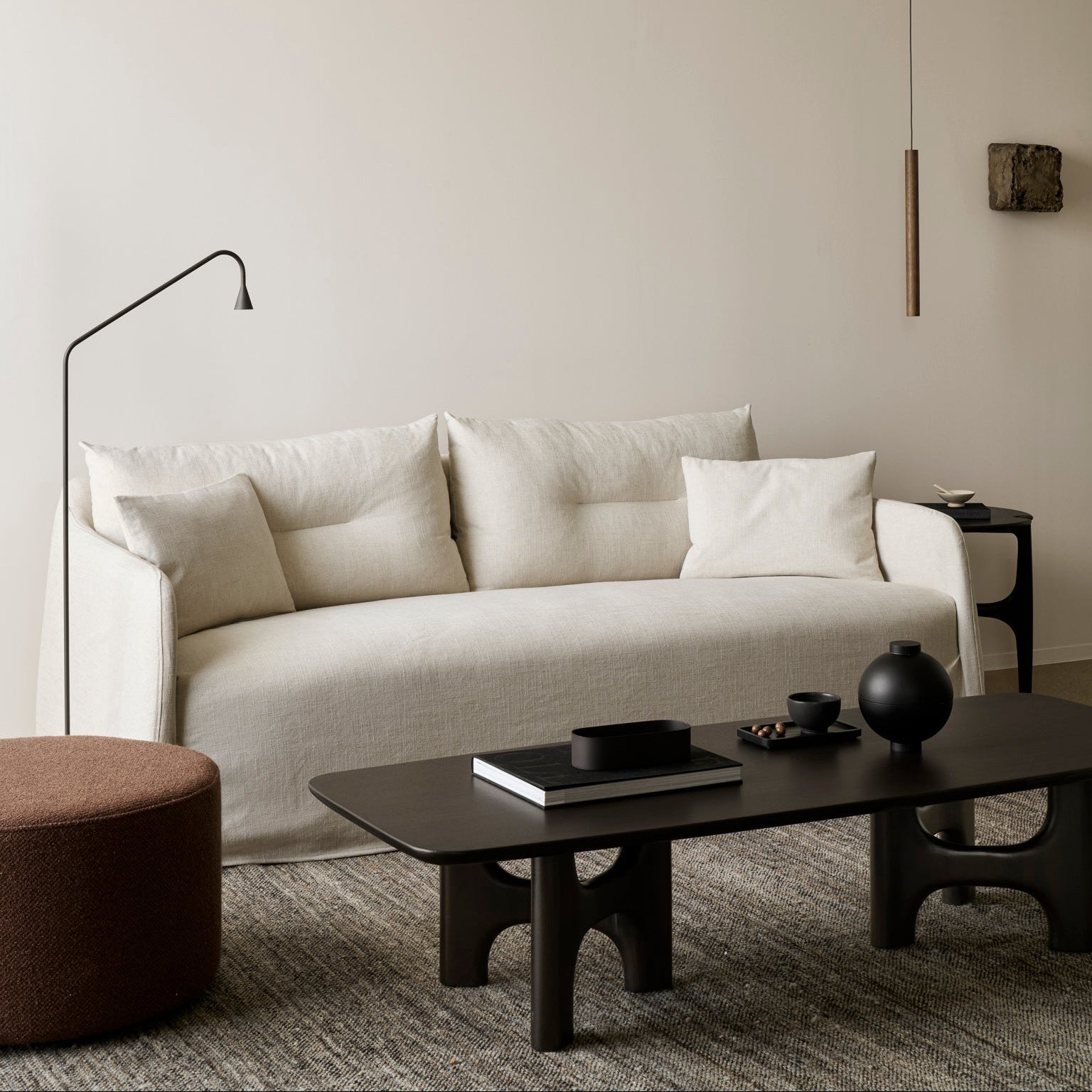 The Ethnicraft Weave Sofa upholstered in bone woven fabric on an FSC-certified solid wood frame, styled in a living room with a coffee table and side table.