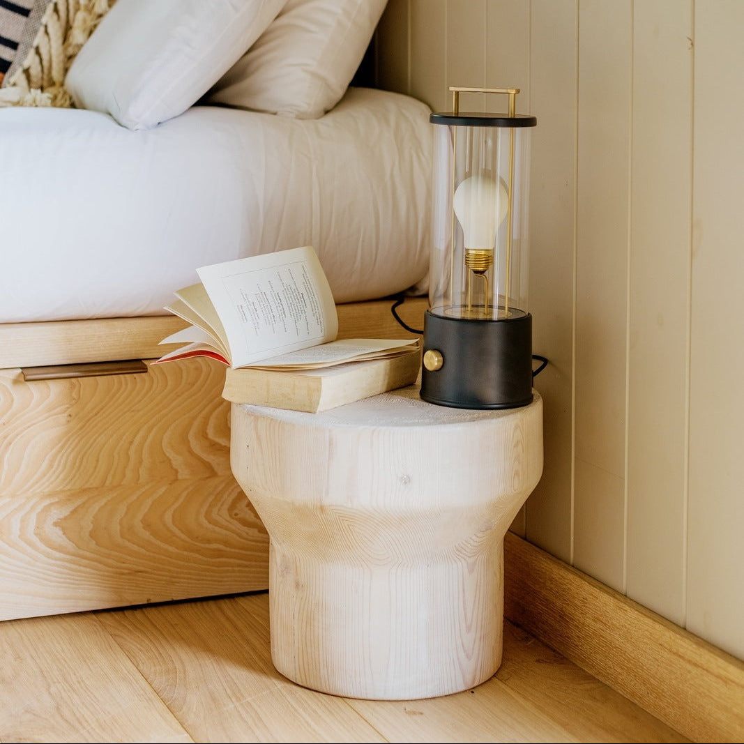Tala Muse portable lamp in powder-coated aluminium with brass details on a bedside table