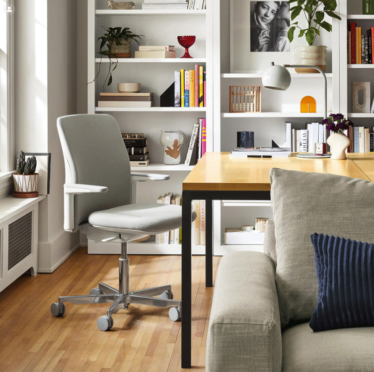 Humanscale Path task chair in a workspace, upholstered in recycled-content knit textile made with reclaimed ocean plastic