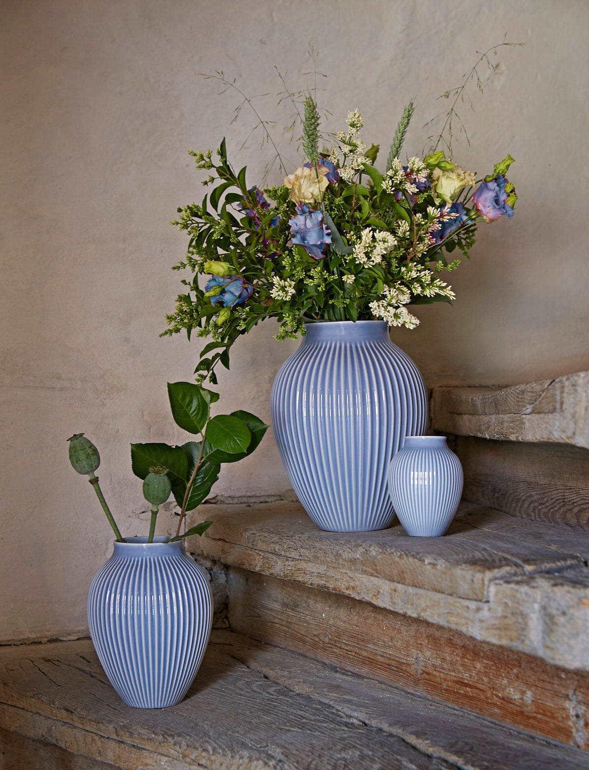 Knabstrup ripple vases in lavender blue with a bunch of garden flowers on stone steps