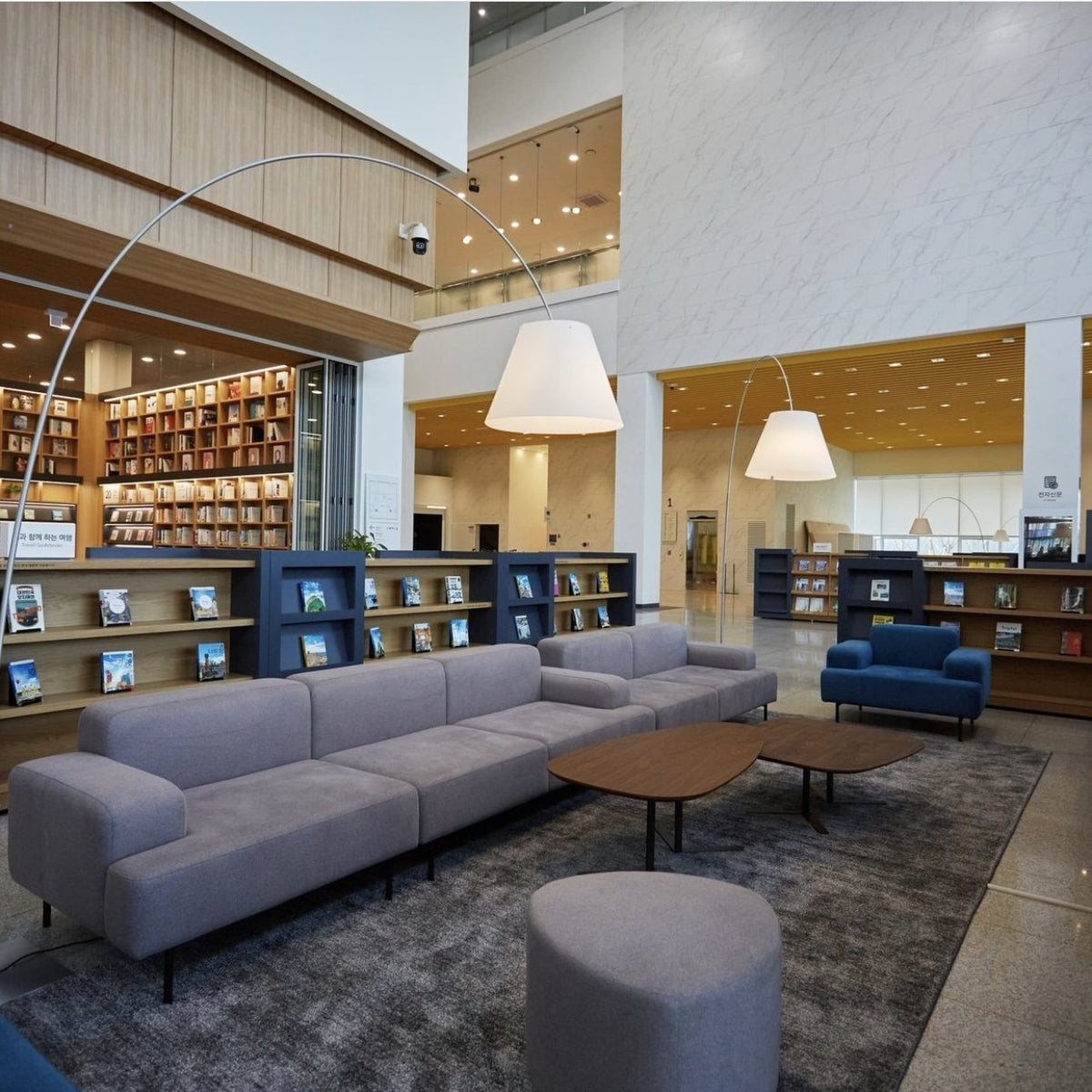 Luceplan Lady Costanza Floor Lamps arching over library seating