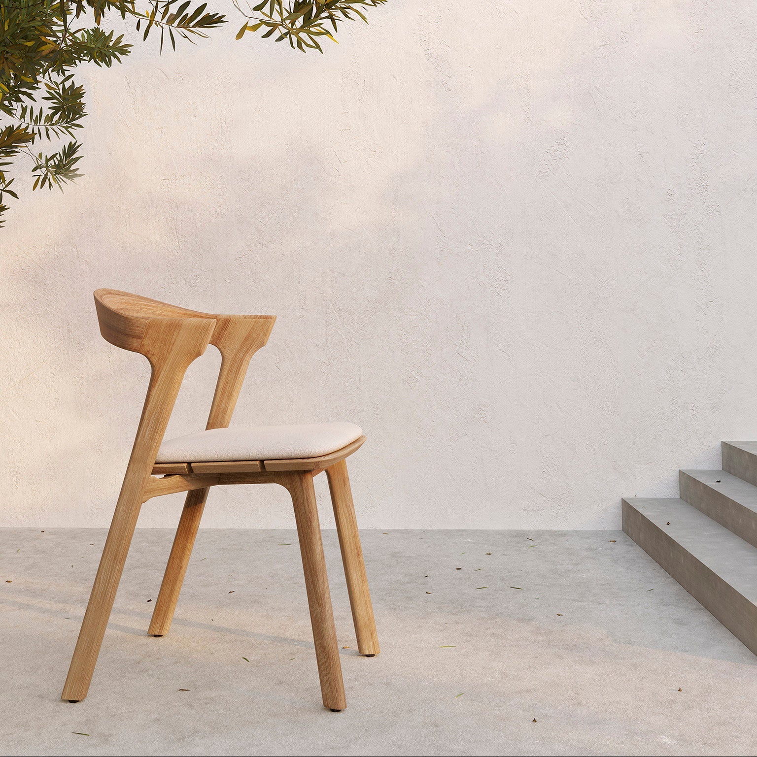 Ethnicraft Bok Outdoor Dining Chair in teak styled in a dining room