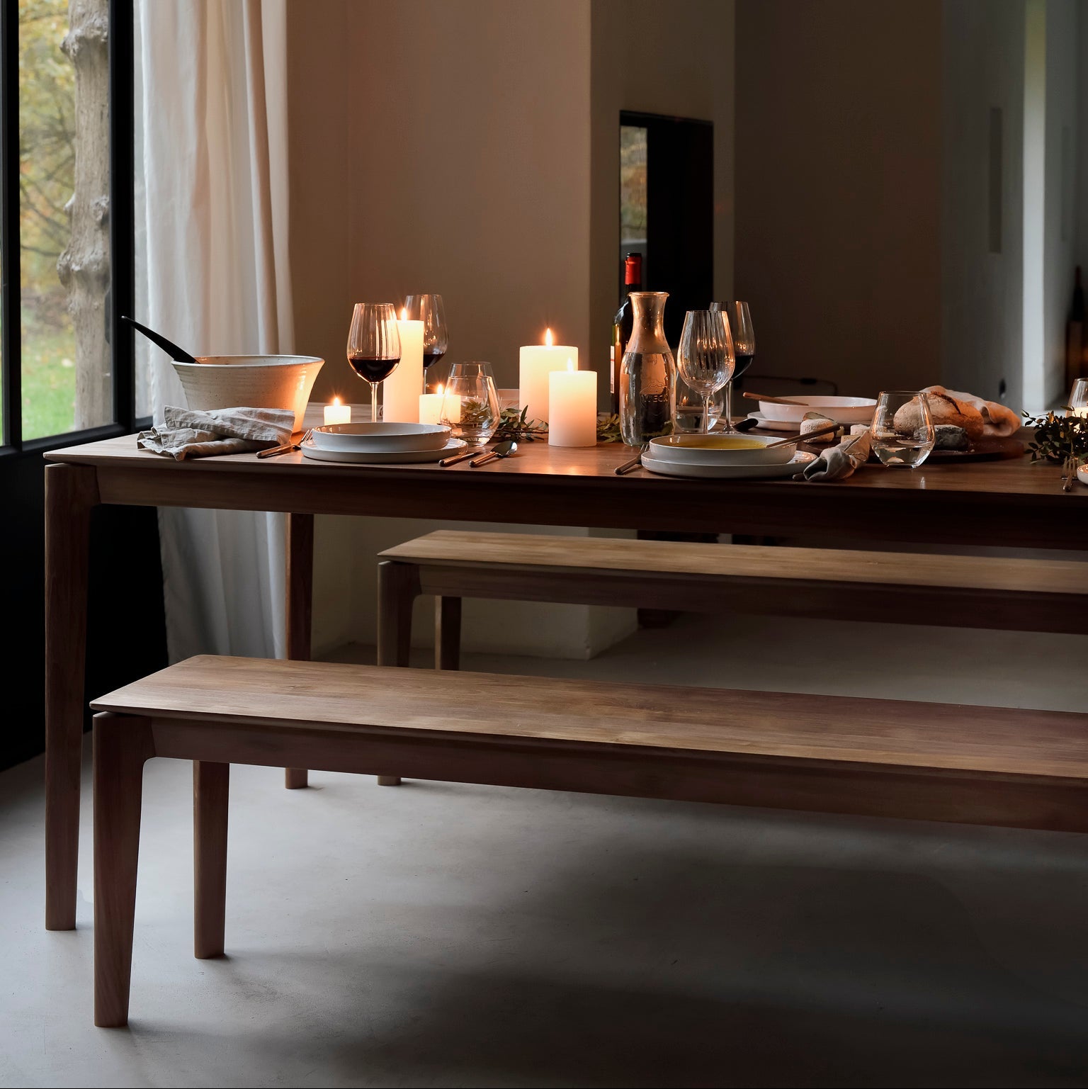Ethnicraft Bok Bench in teak styled in a dining room