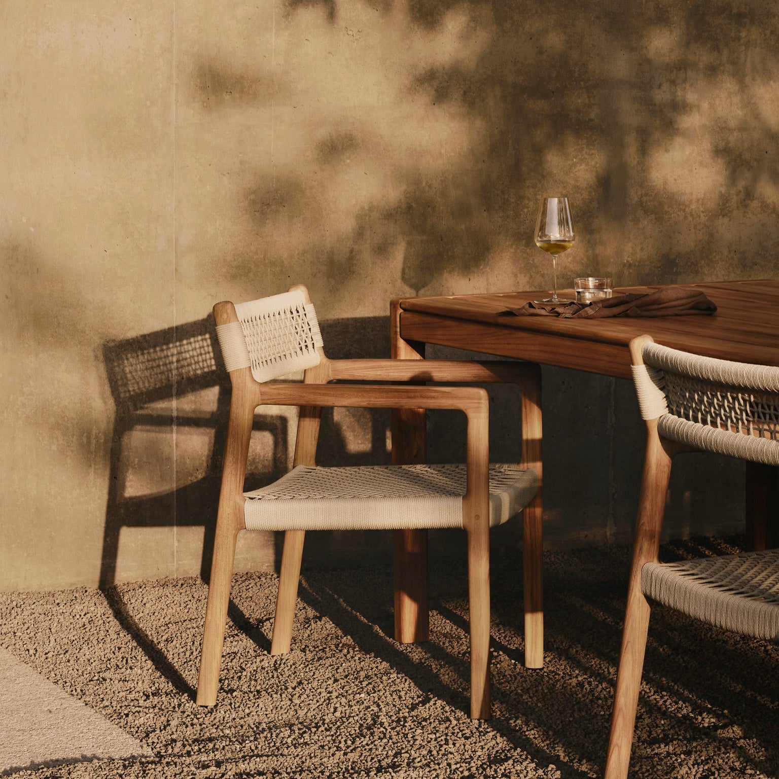 Ethnicraft Jack Woven Outdoor Dining Chair in teak styled in a dining room