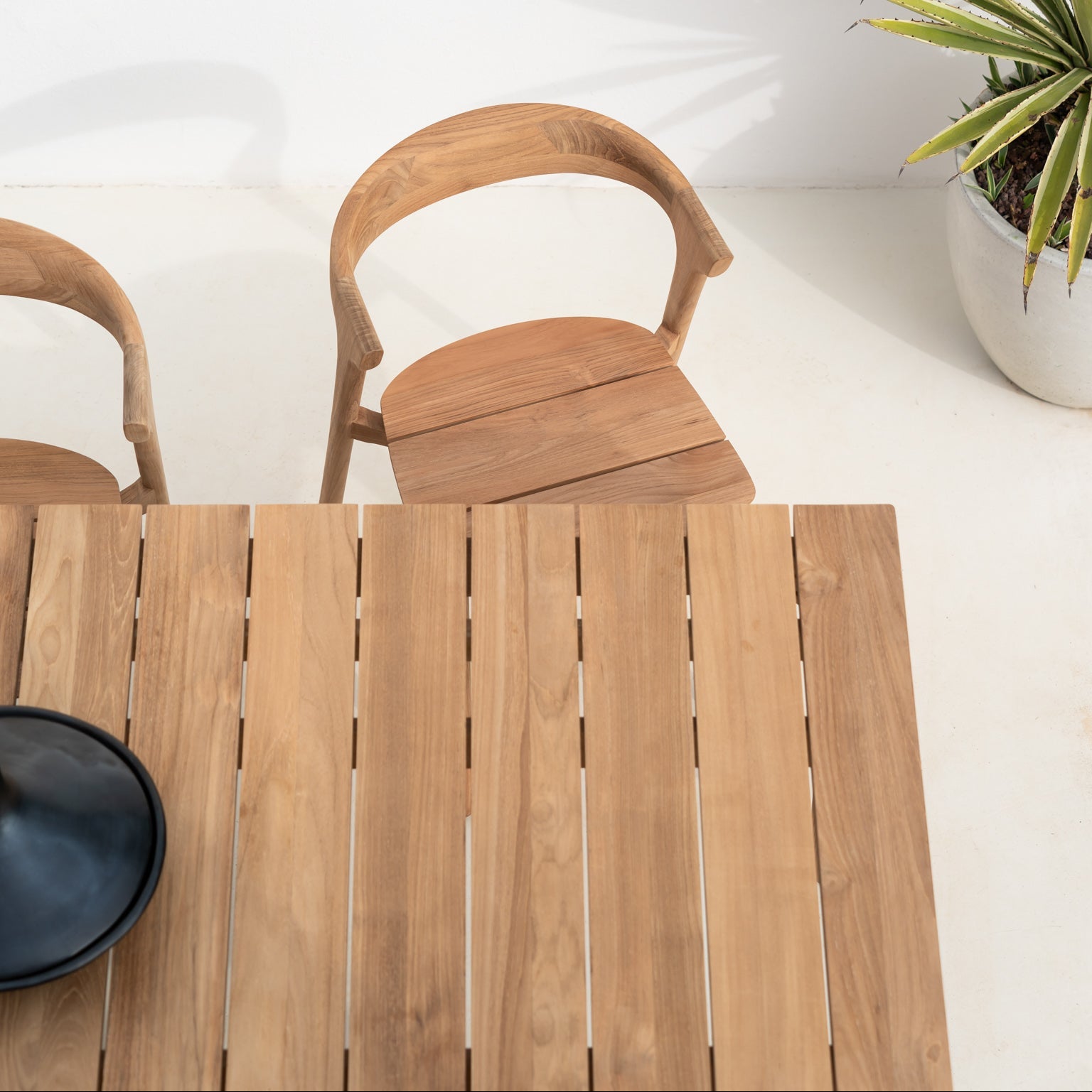Ethnicraft Bok Outdoor Dining Chair in teak styled in a dining room