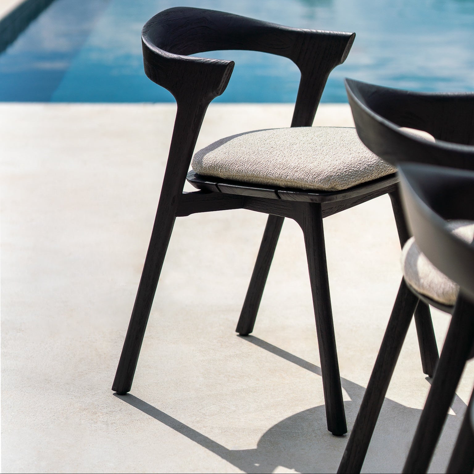 Ethnicraft Bok Outdoor Dining Chair Cushion styled in a dining room