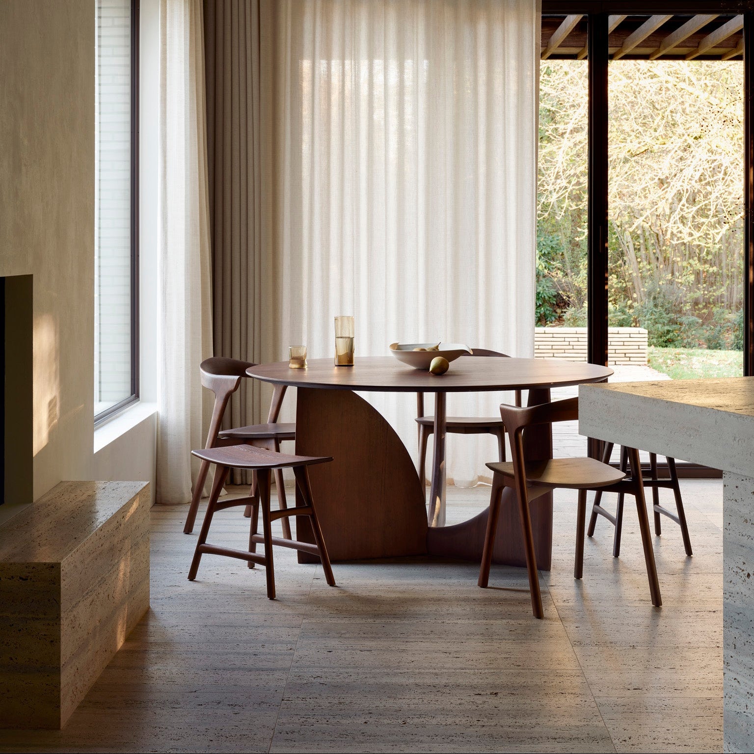 Ethnicraft Geometric Round Dining Table in teak styled in a dining room