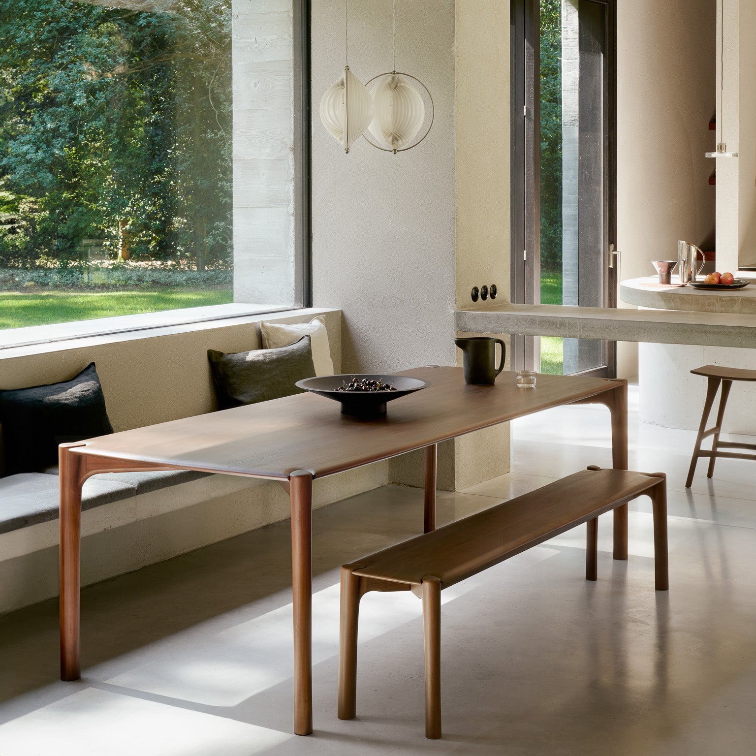 Ethnicraft PI Bench in teak styled in a dining room