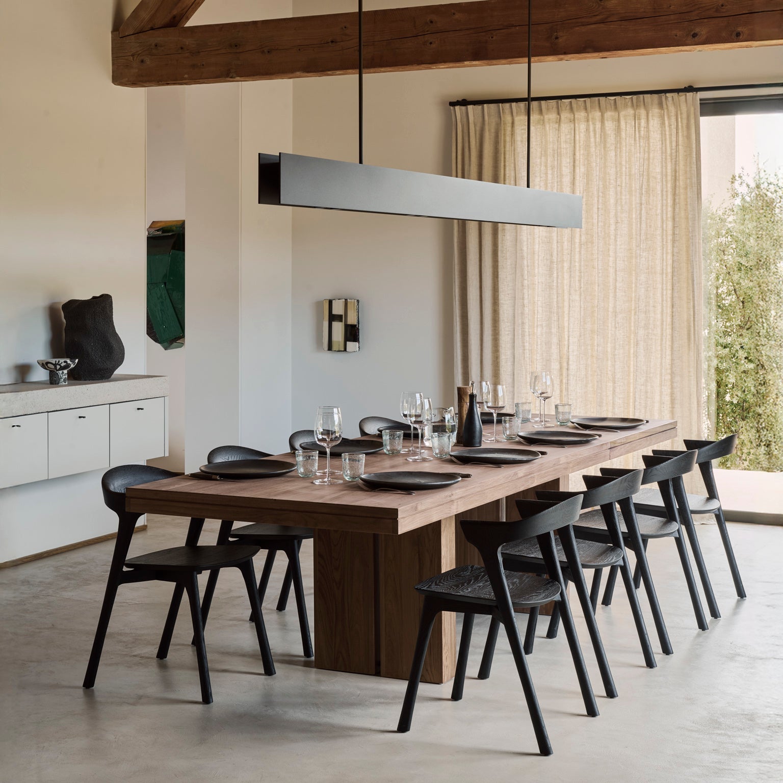 Ethnicraft Double Extendable Dining Table in teak styled in a dining room