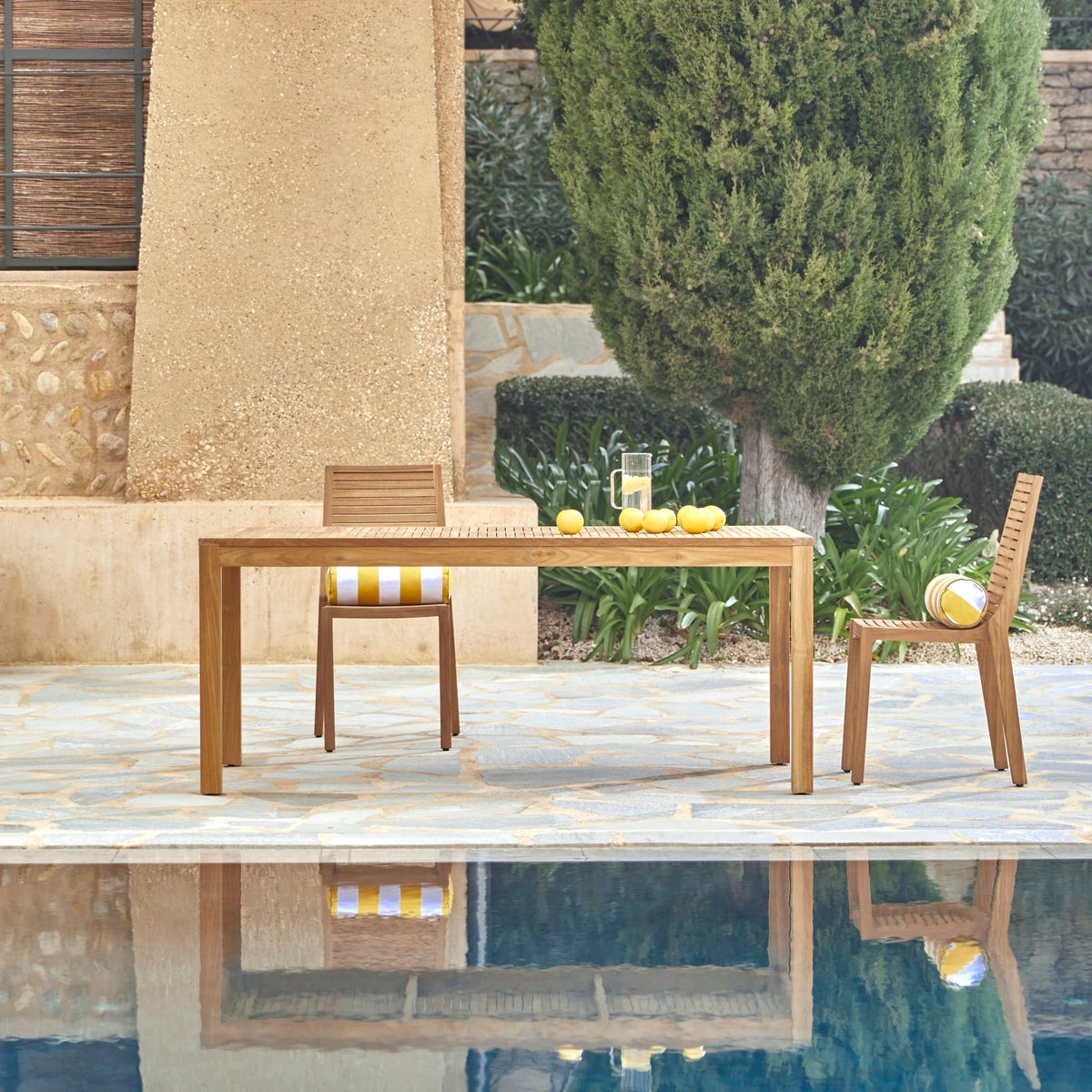 Tikamoon Teo outdoor dining table in solid teak, angled view
