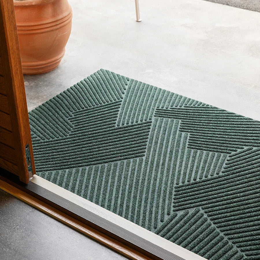 Heymat Strå All Weather Doormat doormat in Green styled in an entryway, recycled PET yarn Norwegian design