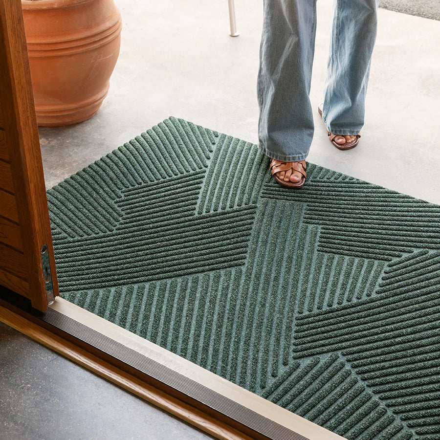 Heymat Strå All Weather Doormat doormat in Green styled in an entryway, recycled PET yarn Norwegian design
