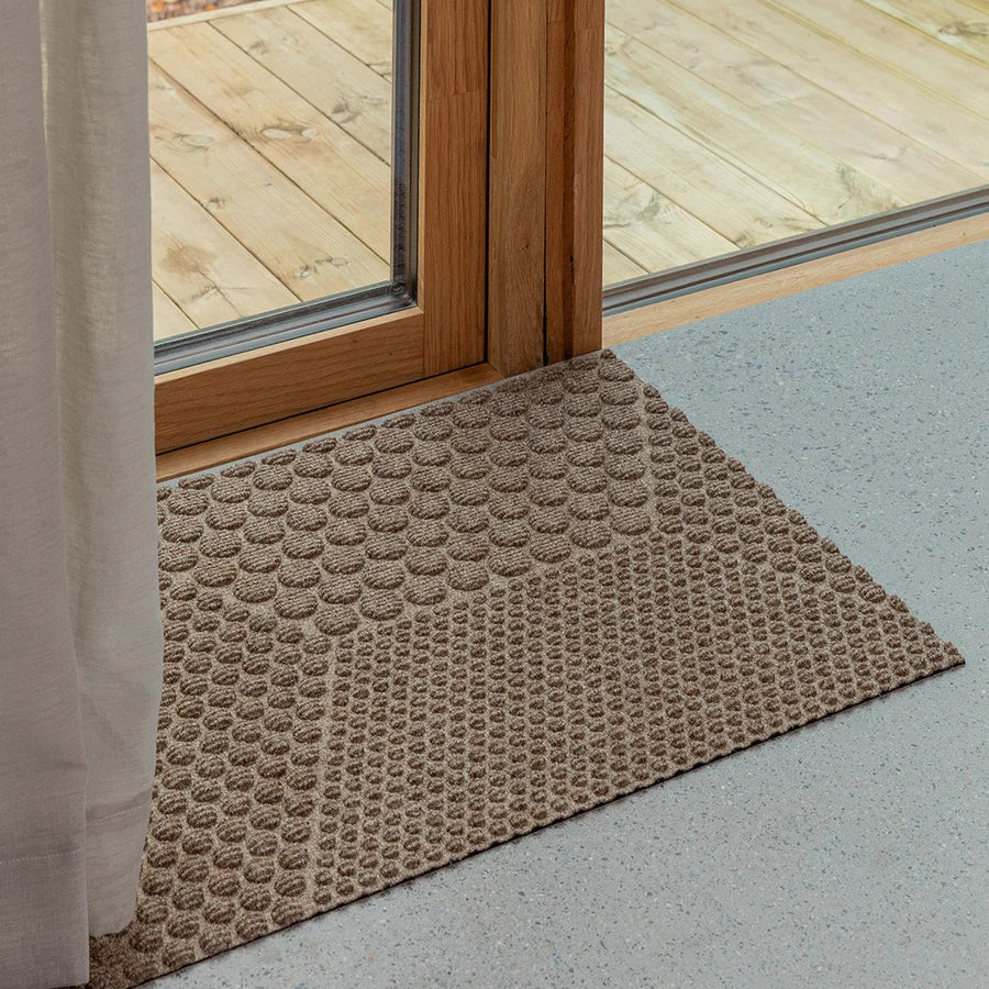 Heymat Hex All Weather Doormat doormat in Desert Beige styled in an entryway, recycled PET yarn Norwegian design