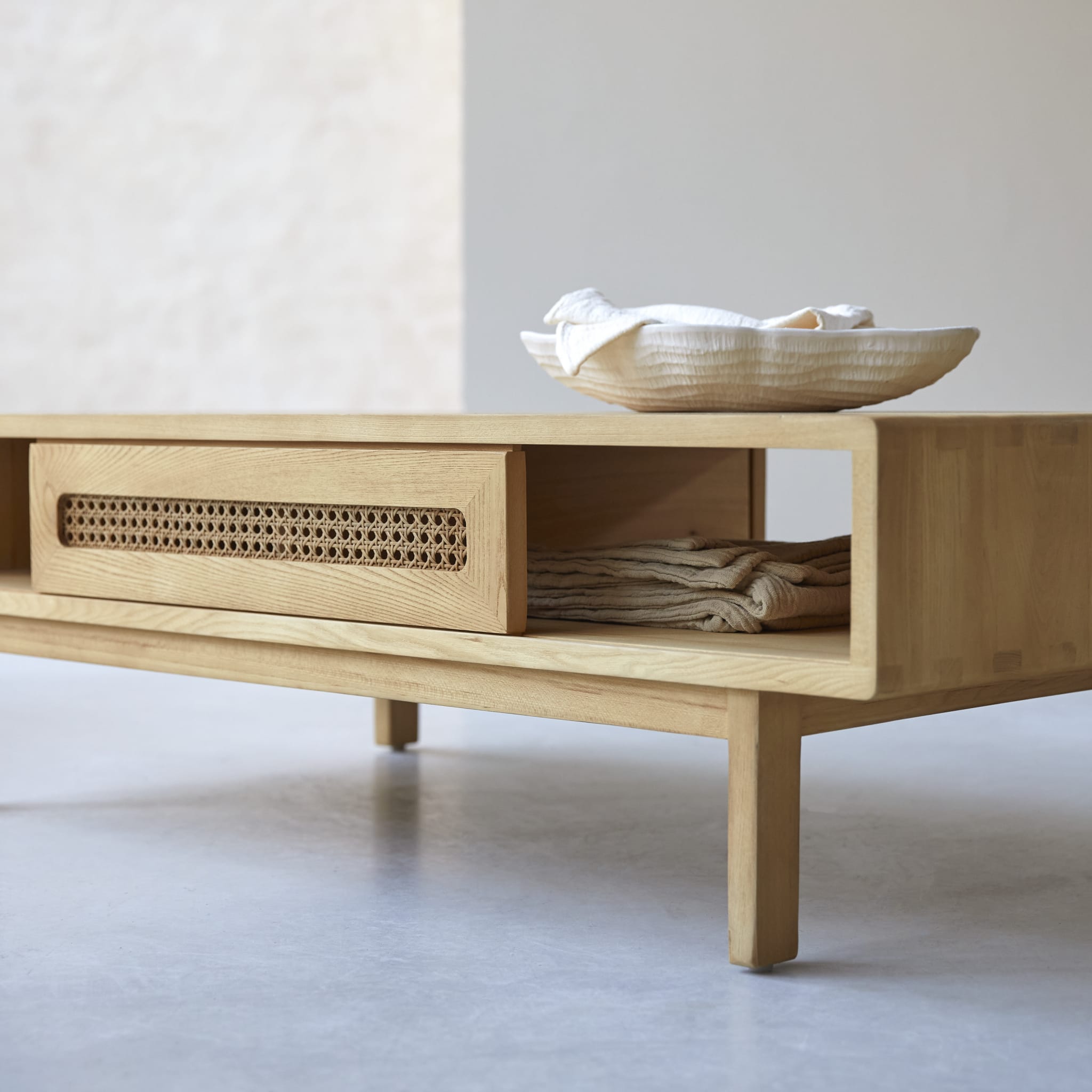 Tikamoon Luis coffee table in solid elm with canework detailing, side view