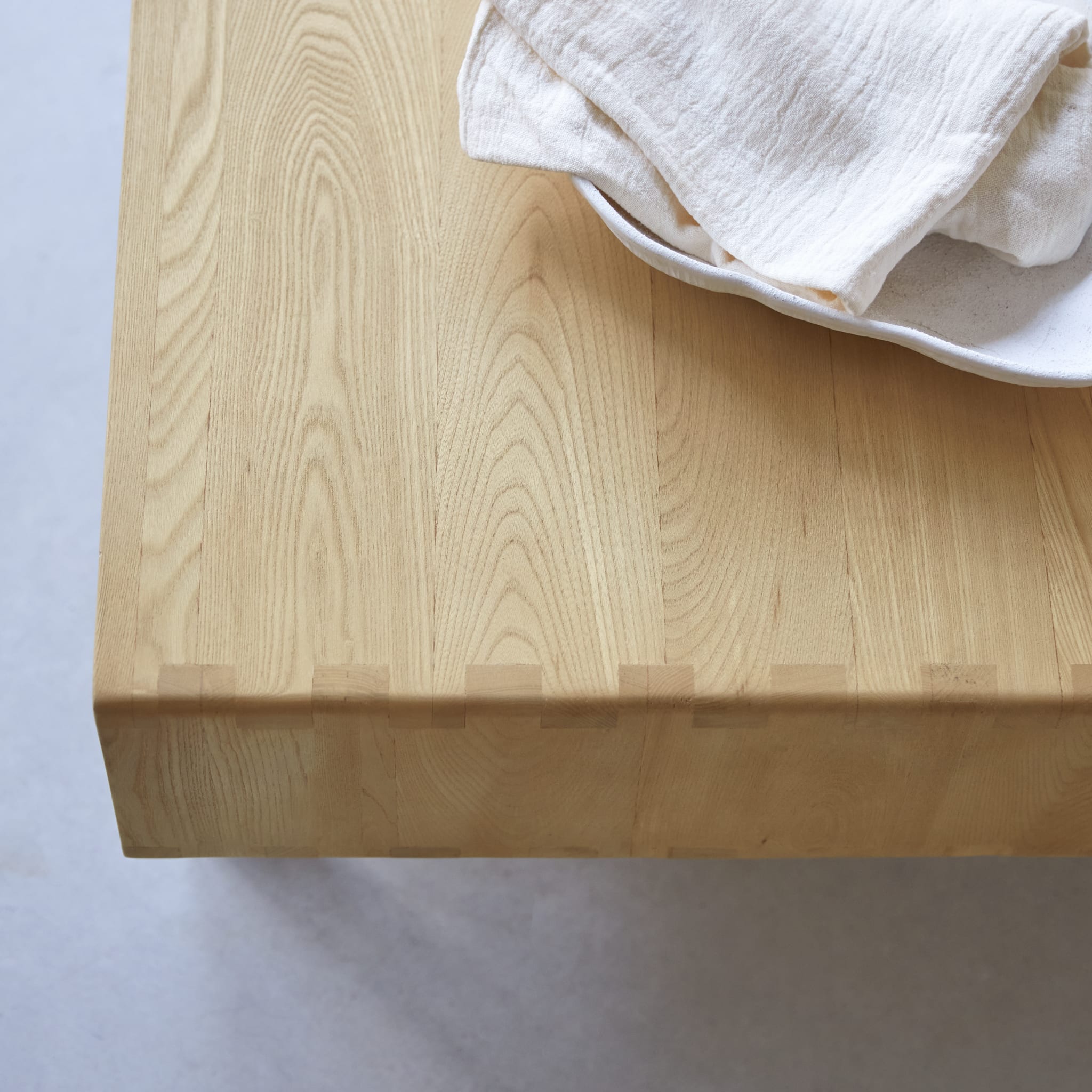 Tikamoon Luis coffee table in solid elm with canework detailing, three-quarter view