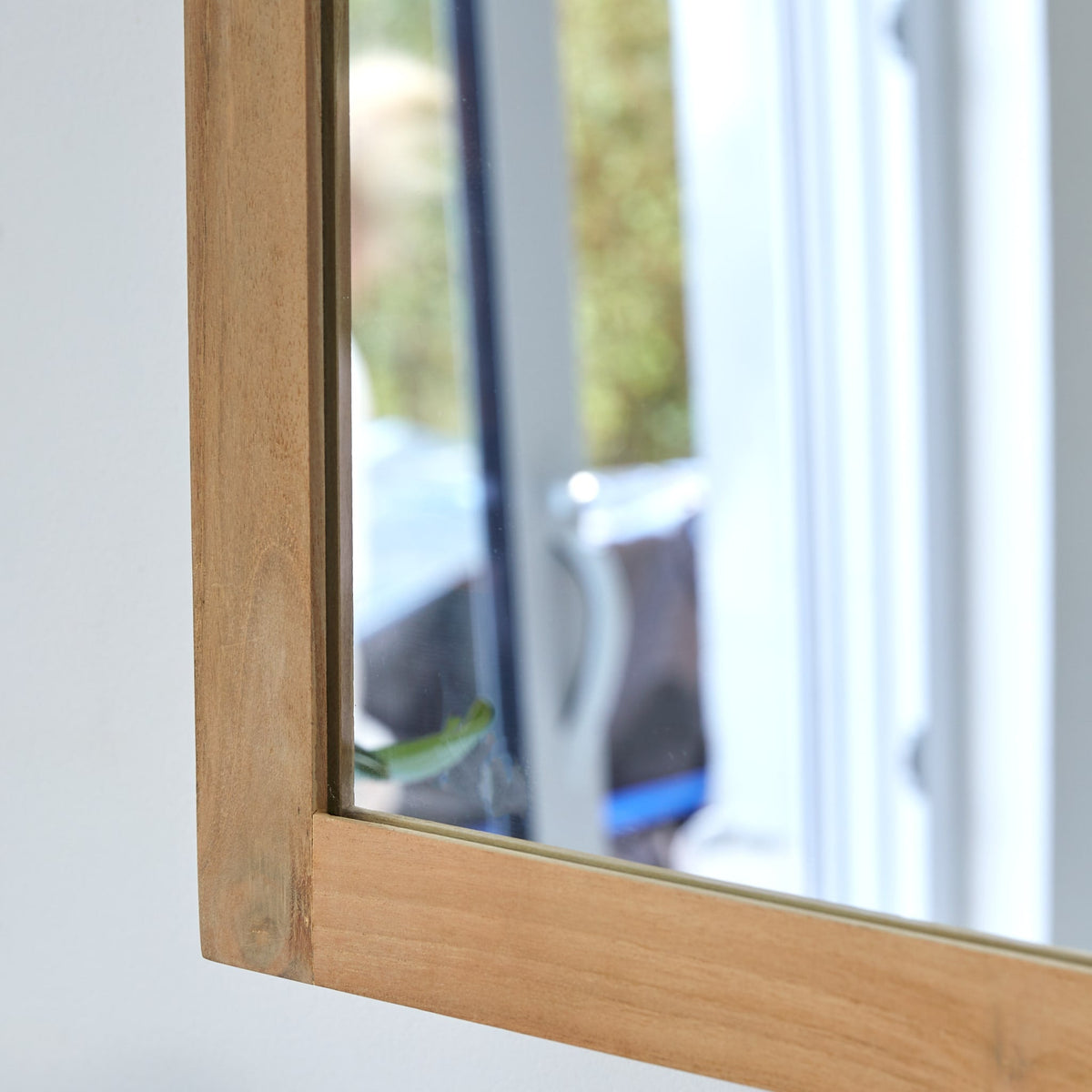 Close-up of the Jill cabinet teak frame and mirror door