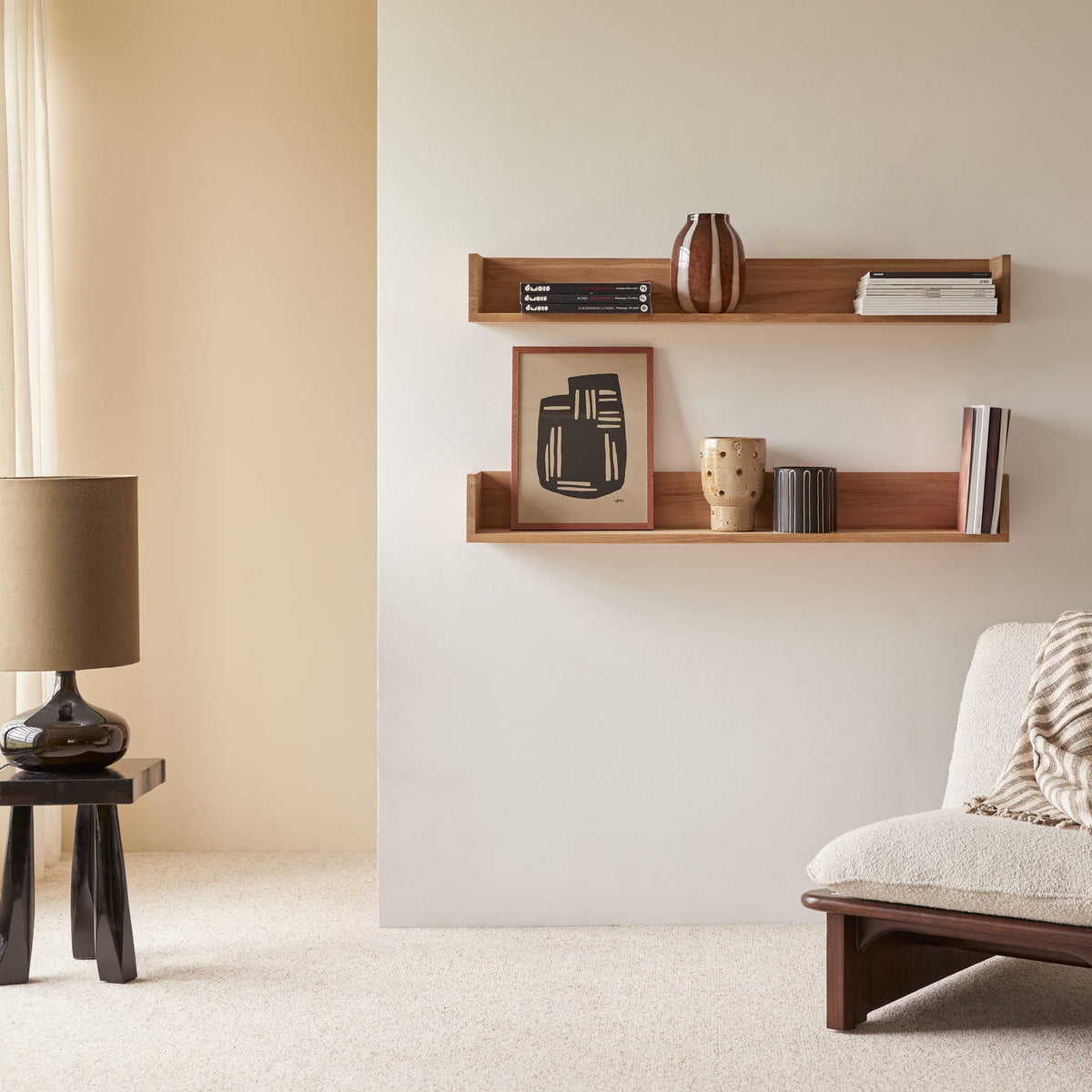 Two Tikamoon Arty teak shelves displaying books and vases