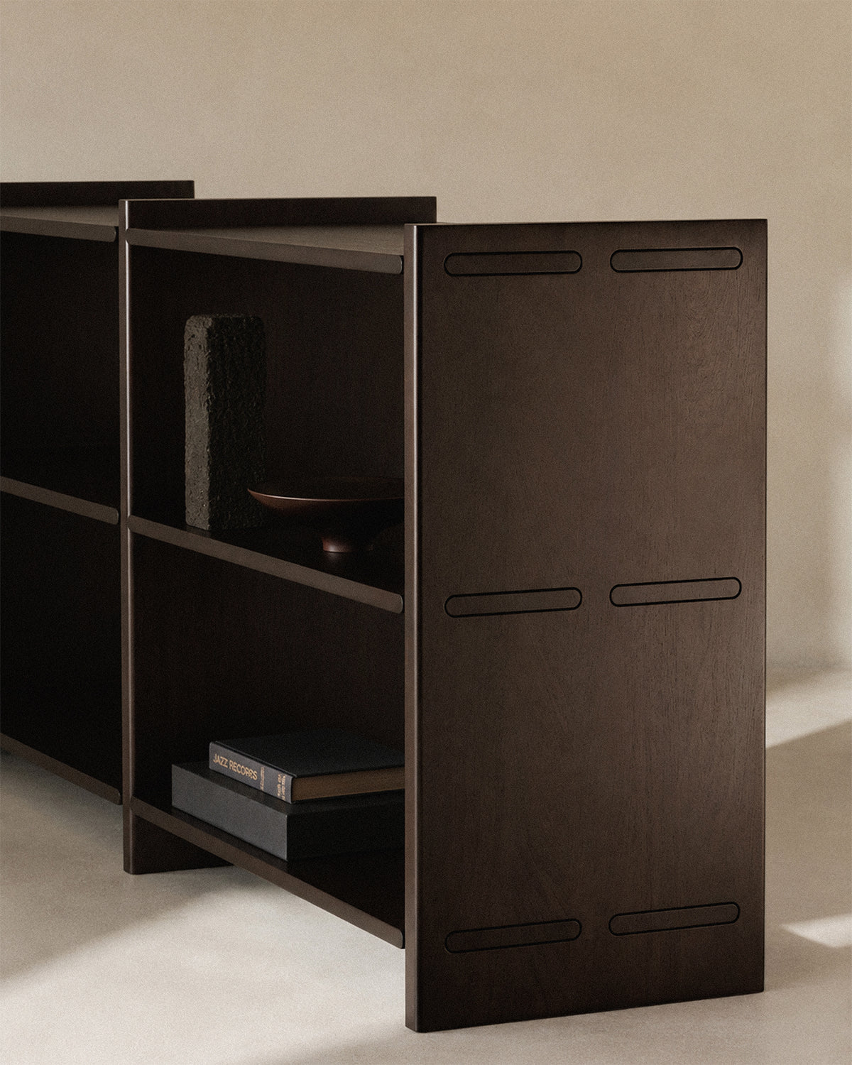 Ethnicraft Mortise Rack in Rose Brown, styled in an interior setting, solid mahogany