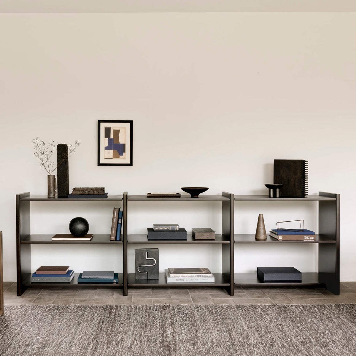 Ethnicraft Mortise Rack with Roan lounge chair, styled in an interior setting, solid mahogany