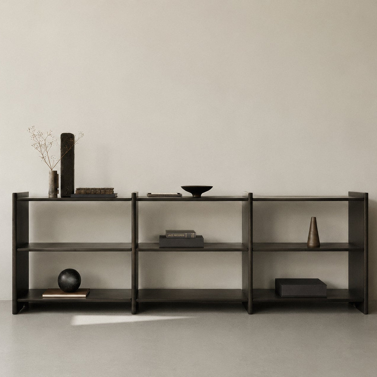 Ethnicraft Mortise Rack in Rose Brown, styled in a living room, solid mahogany
