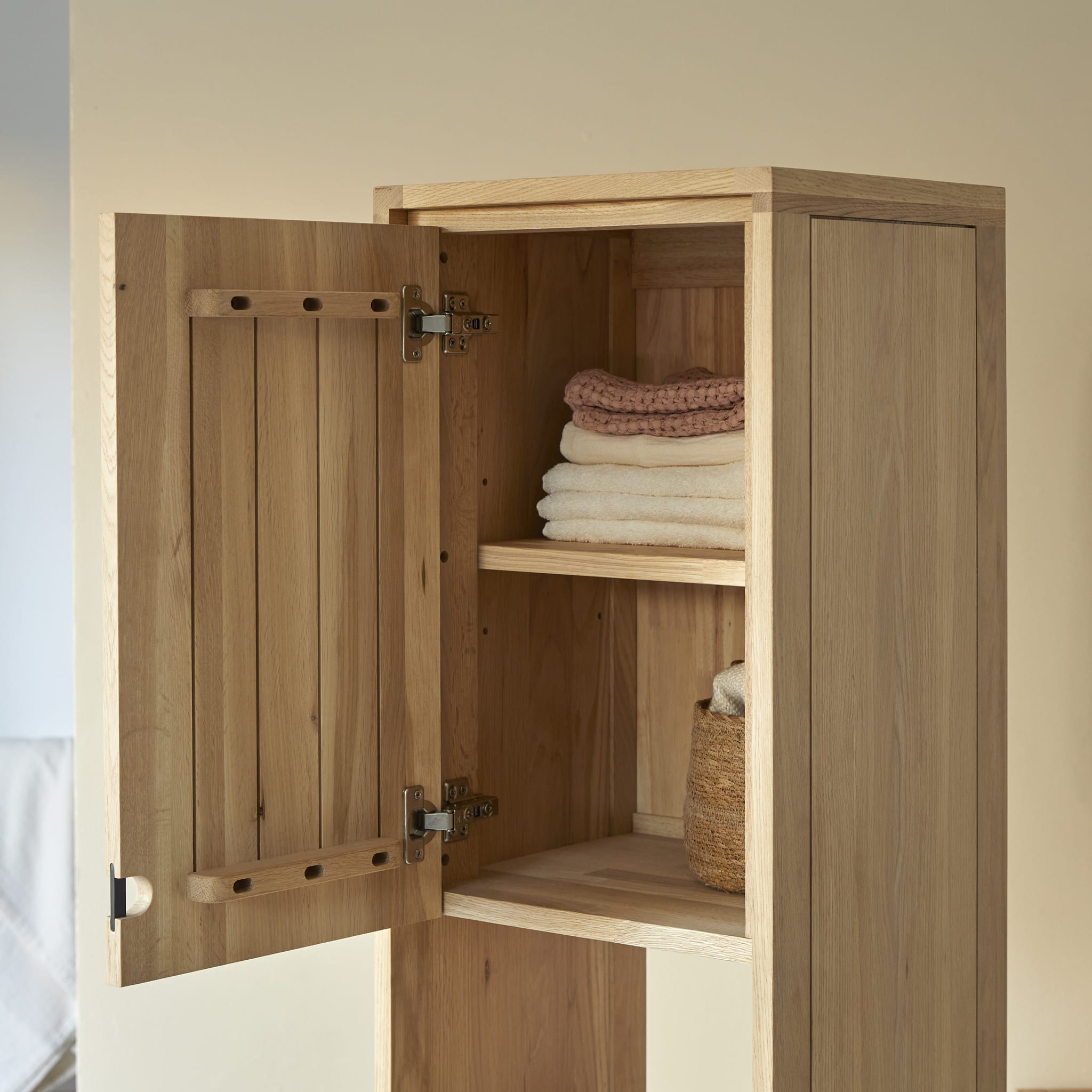 Tikamoon Jonàk tall bathroom cabinet in solid oak, angled view