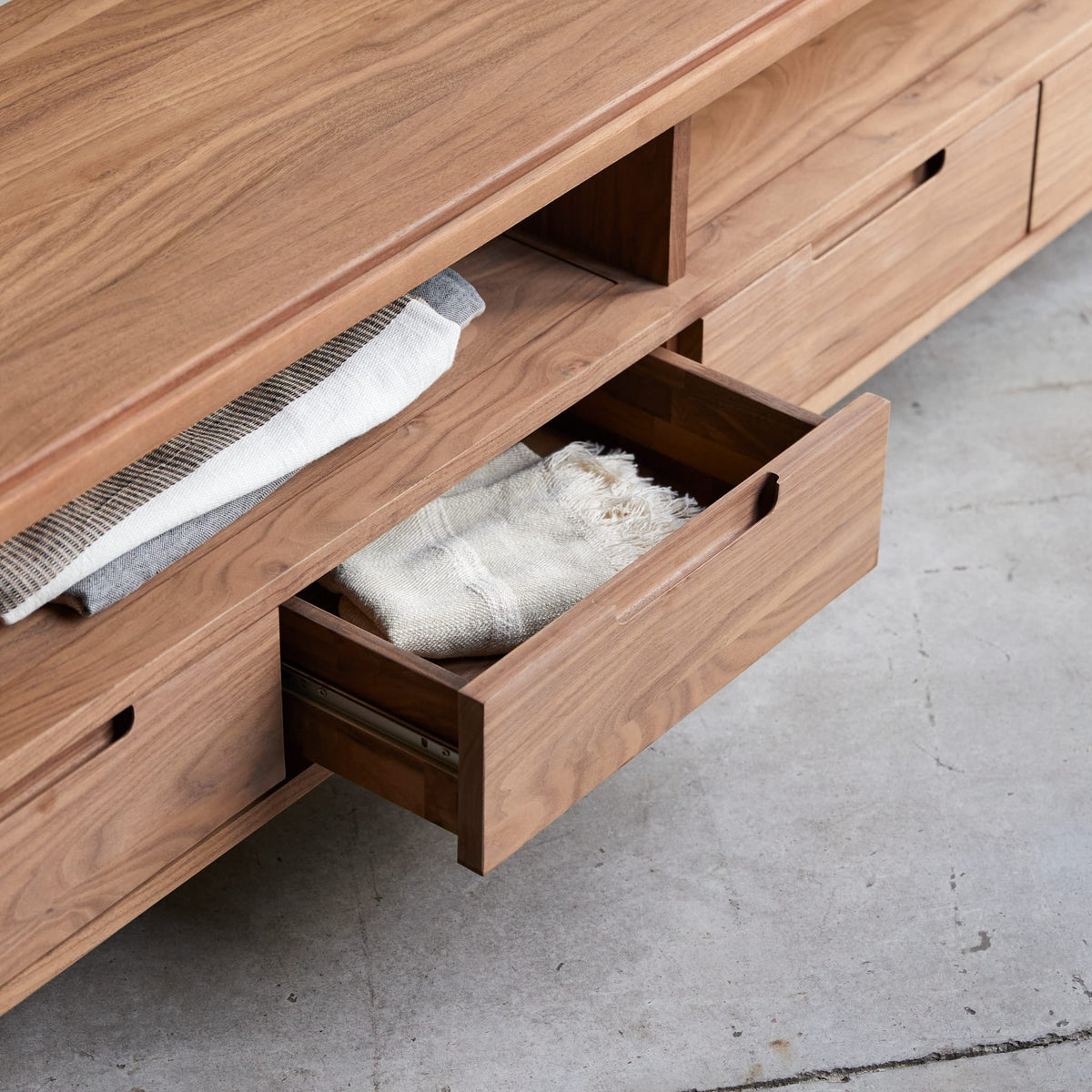 Tikamoon Arto TV stand in solid walnut, front view of the four drawers