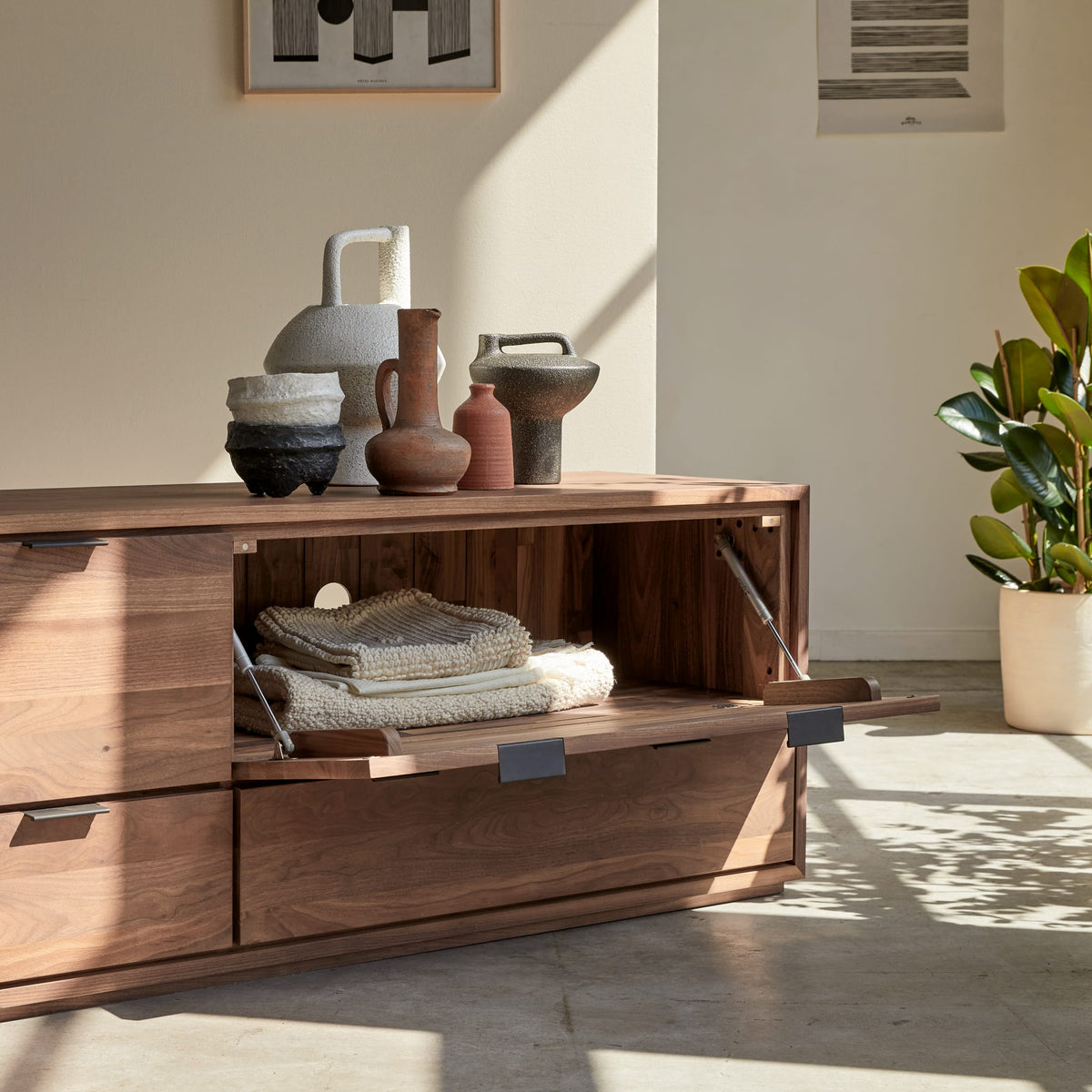 Tikamoon Senson TV stand in solid walnut, front view with doors and drawers closed