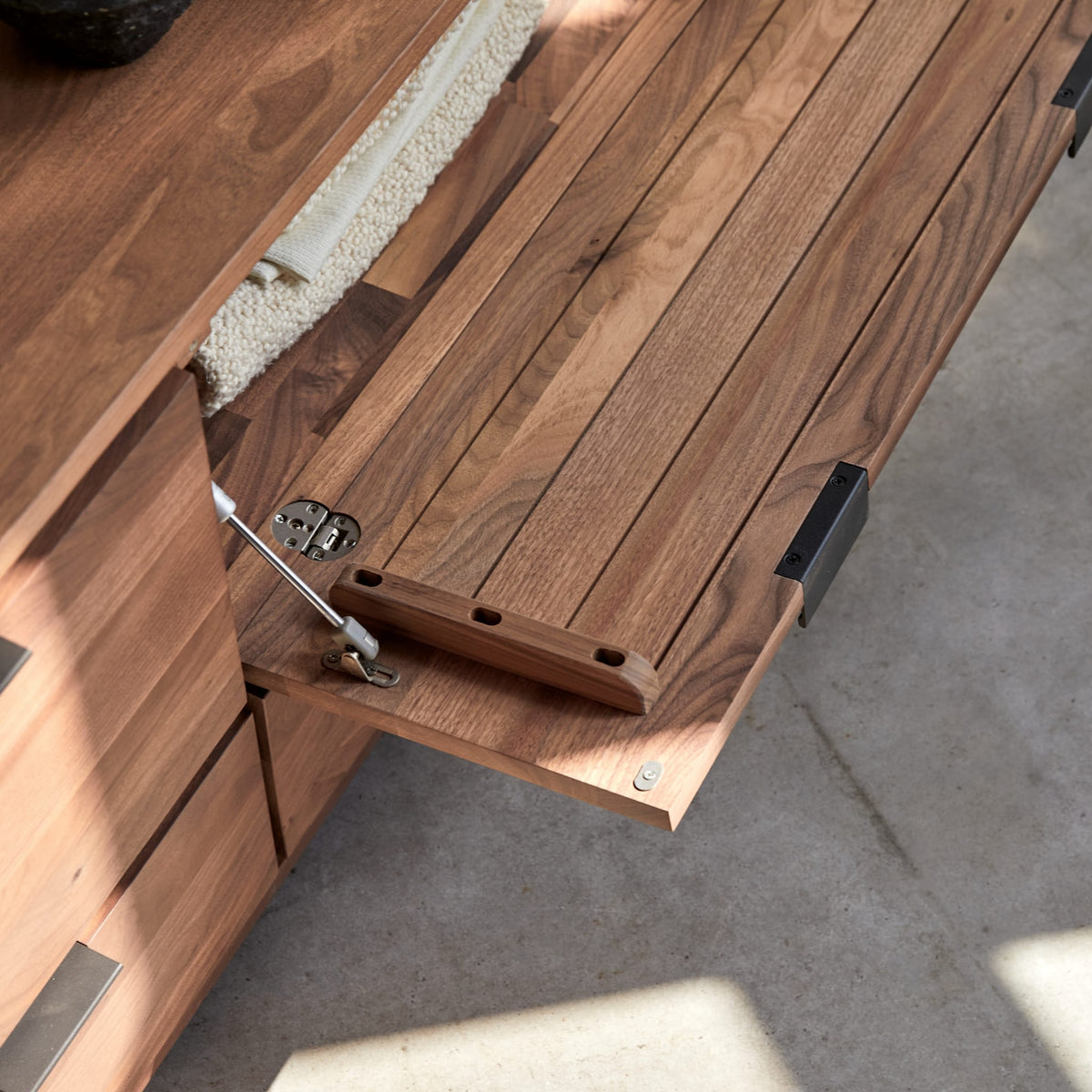 Tikamoon Senson TV stand in solid walnut, close-up of the walnut grain