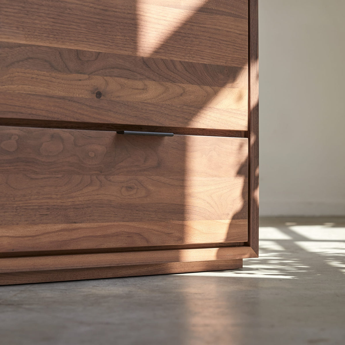 Tikamoon Senson TV stand in solid walnut, detail of a drawer front