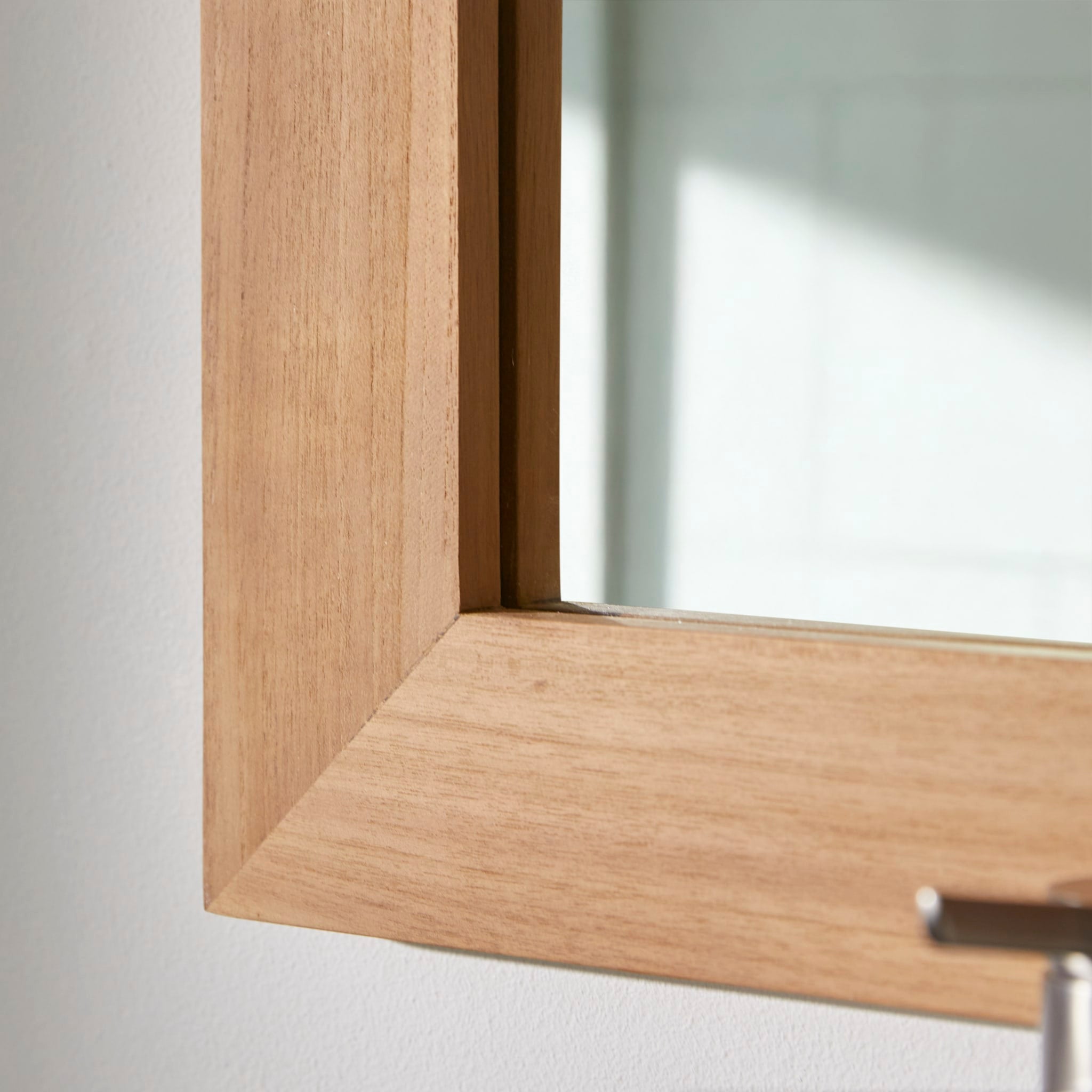 Tona teak mirror hung above a bathroom vanity