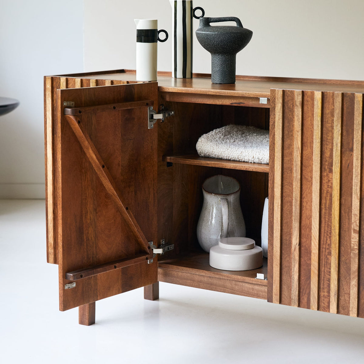 Tikamoon Milo sideboard in solid mango wood, three-quarter view