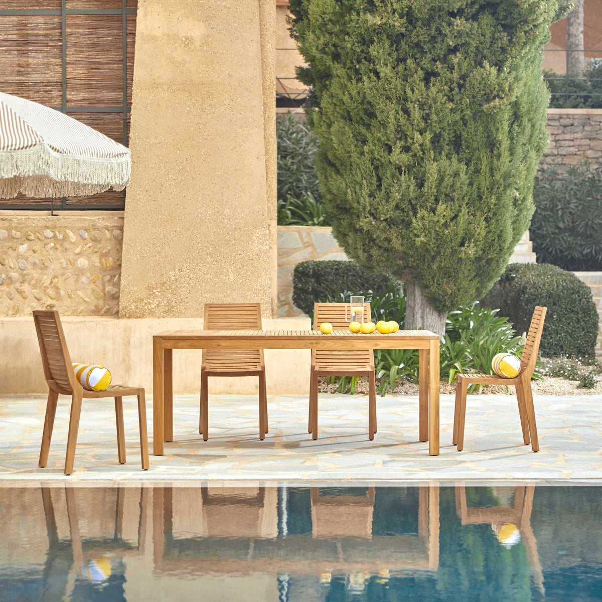 Tikamoon Teo outdoor dining set in solid teak, angled view of table and chairs