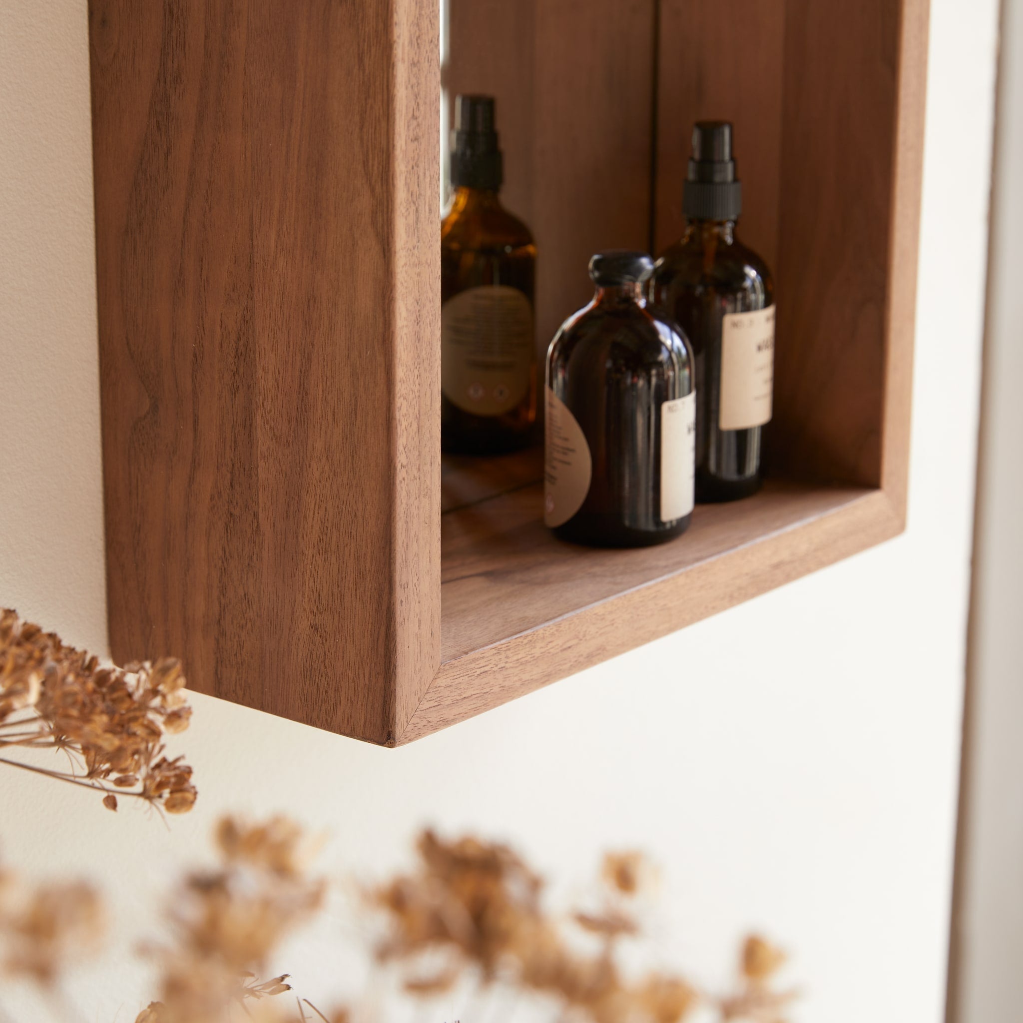 Stelle walnut mirror hung vertically above a bathroom vanity
