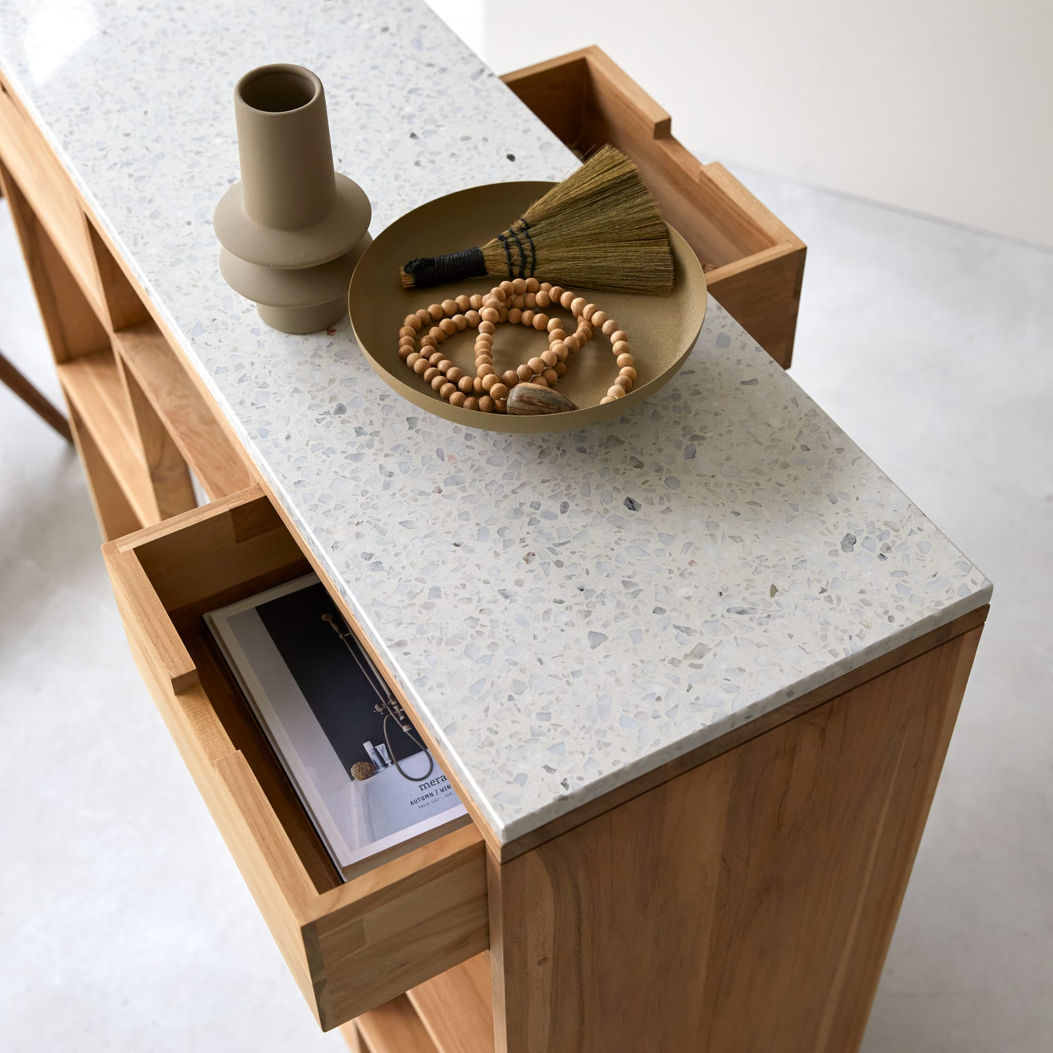 Tikamoon Miho console table in solid teak with a terrazzo top, three-quarter view
