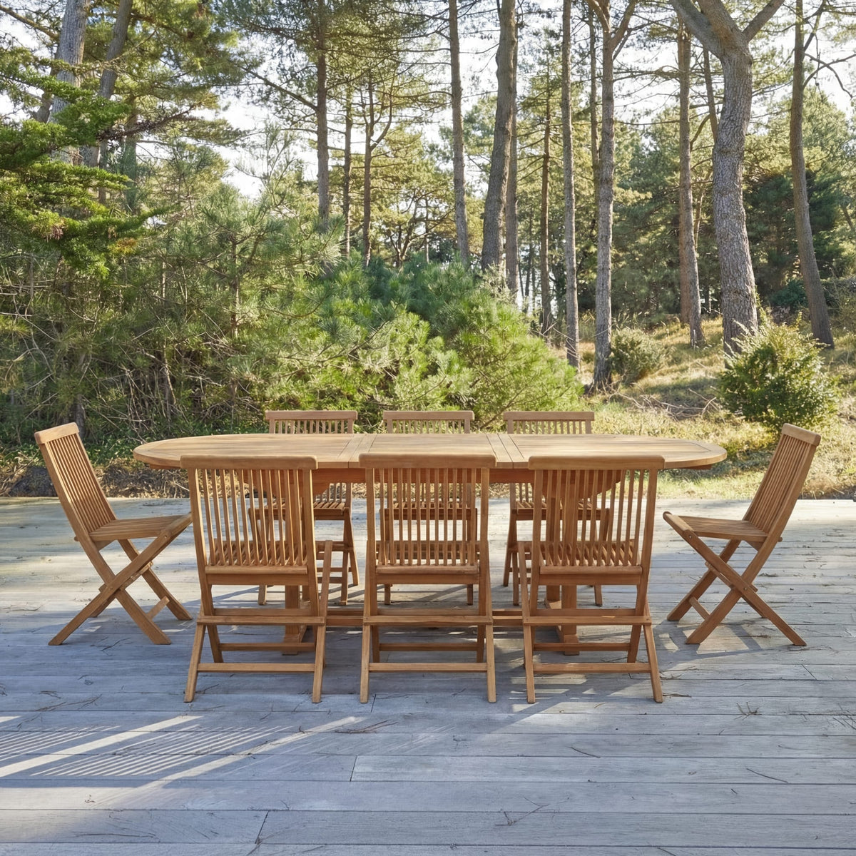 Tikamoon Capri oval dining set in solid acacia, table and eight chairs, angled view