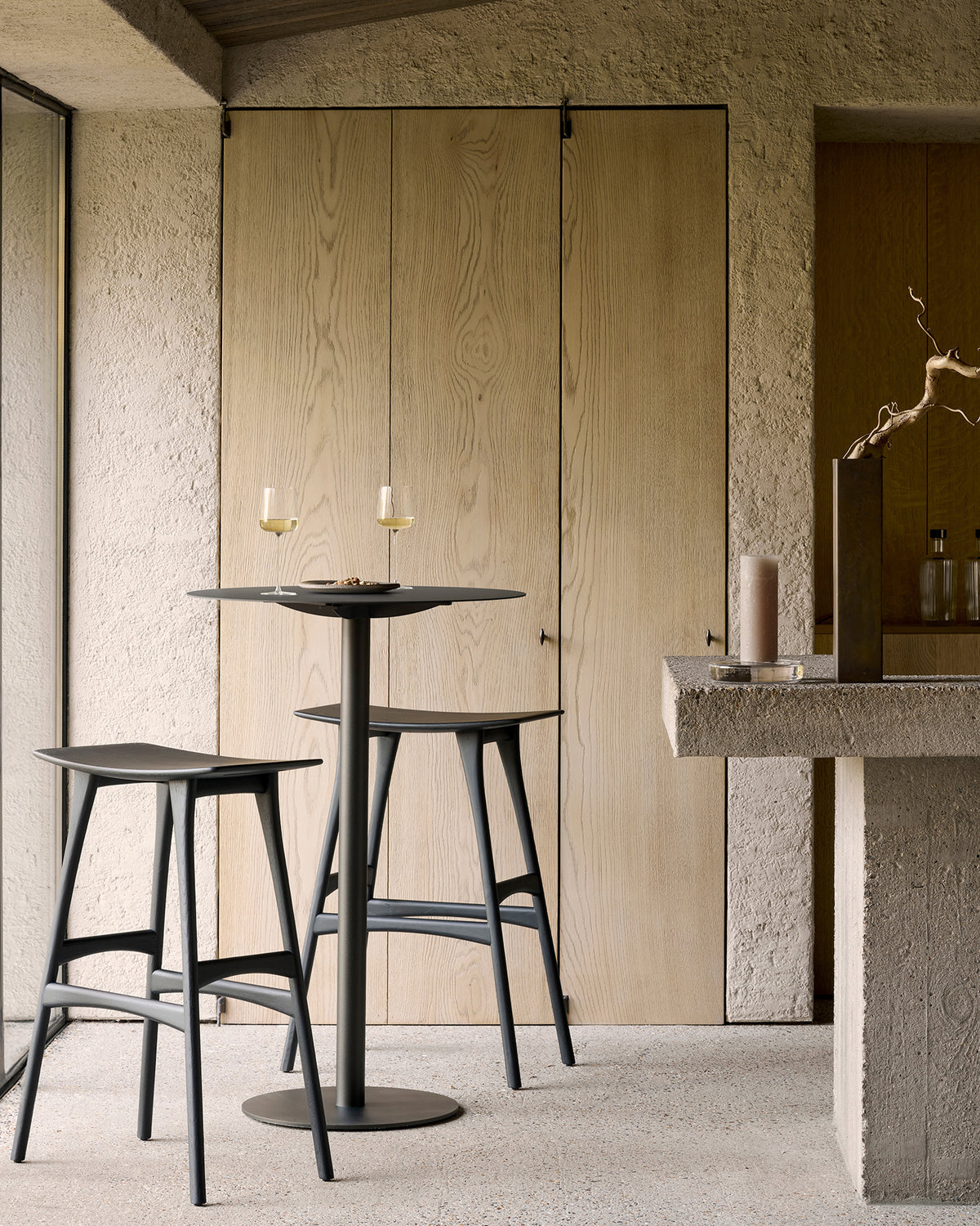 Ethnicraft Blend Bar Table in Dark Bronze Metal, styled with bar stools, powder-coated metal