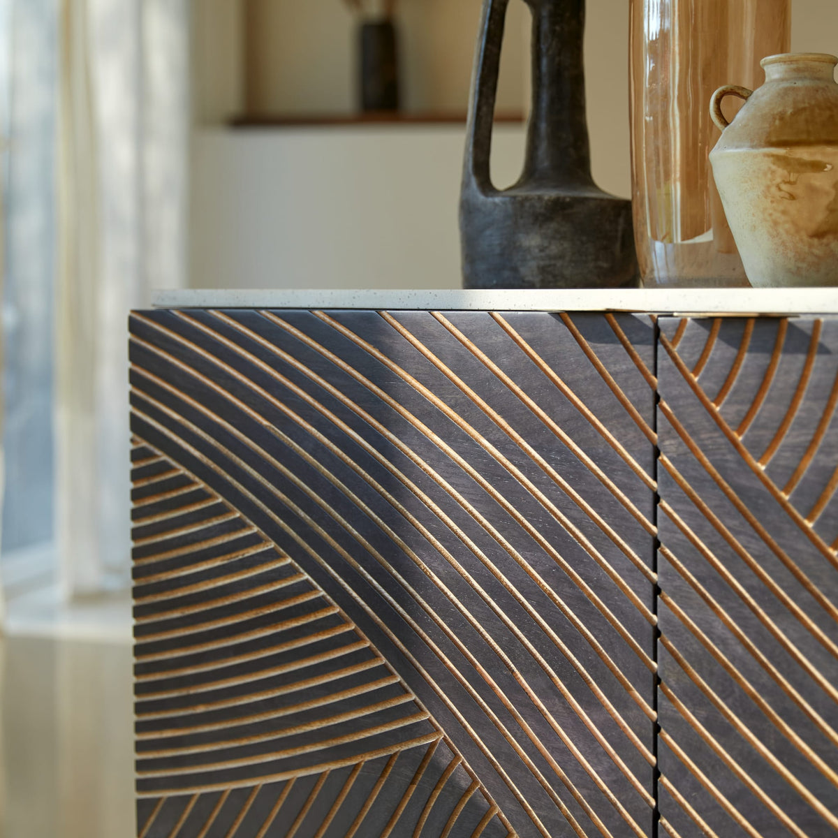 Tikamoon Bilal mango sideboard, angled view showing the brass legs
