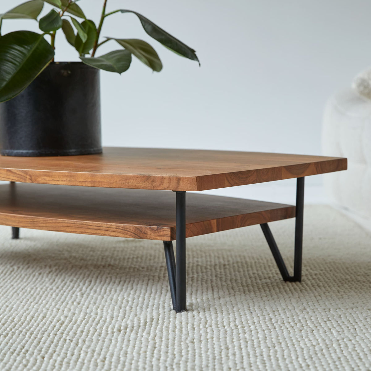 Tikamoon Bonnie coffee table in solid acacia with metal legs, front view showing the lower shelf