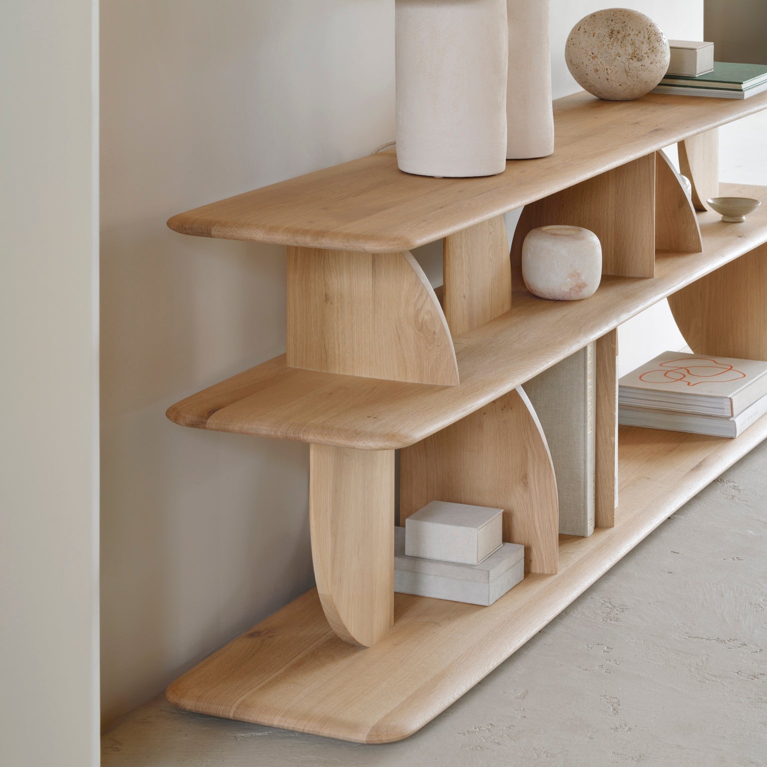 Wooden shelf with decorative items against a neutral wall